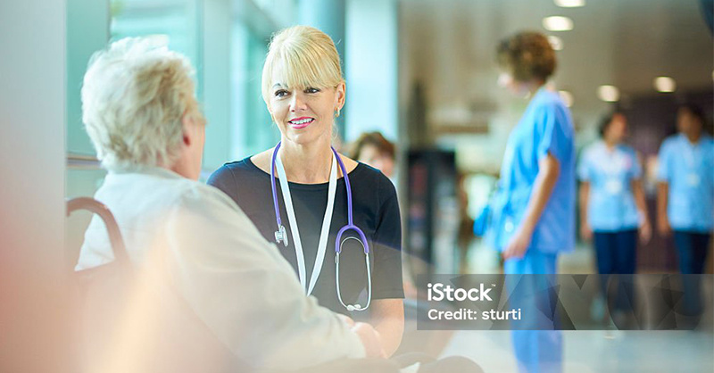 nurse sitting with patient before leaving the hospital
